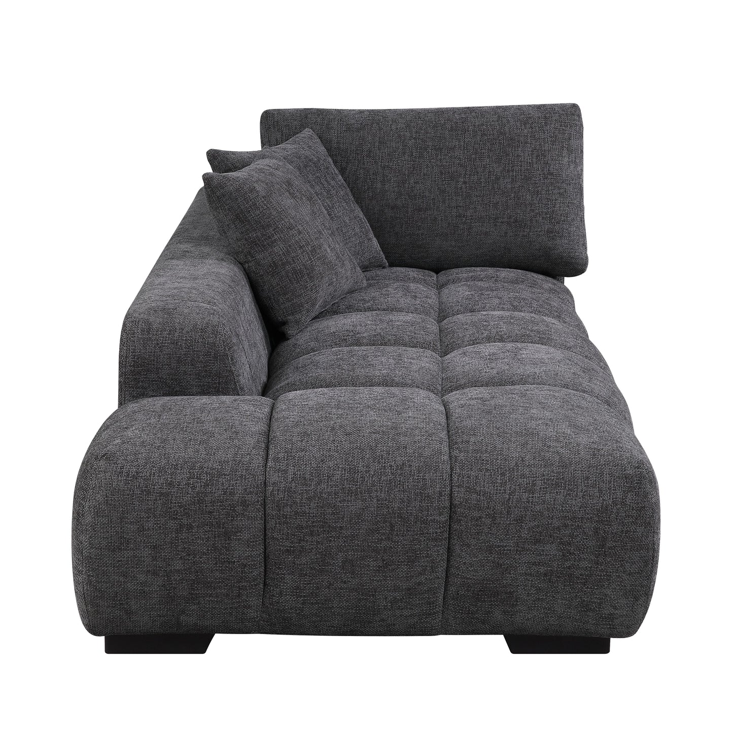 Dark grey fabric sectional sofa with tufted seat cushions and two throw pillows