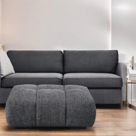 Tufted dark grey fabric ottoman with modern design perfect for living rooms