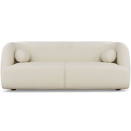 Cream boucle fabric sofa with rounded arms and two circular accent pillows