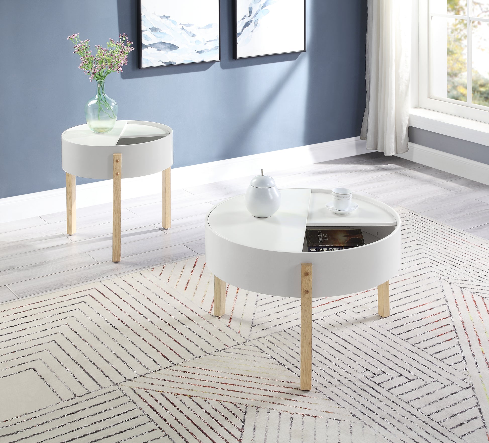 Modern white round coffee table with angled wooden legs and storage compartments perfect for living rooms