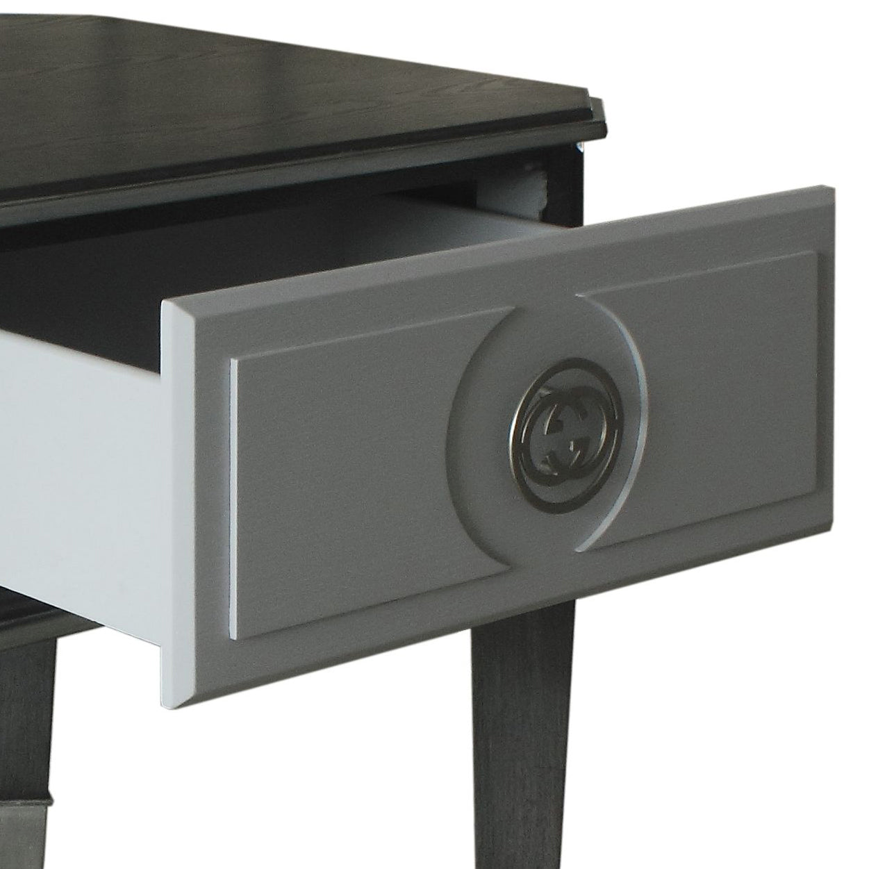 Grey designer nightstand with an open drawer featuring a distinctive circular metal pull