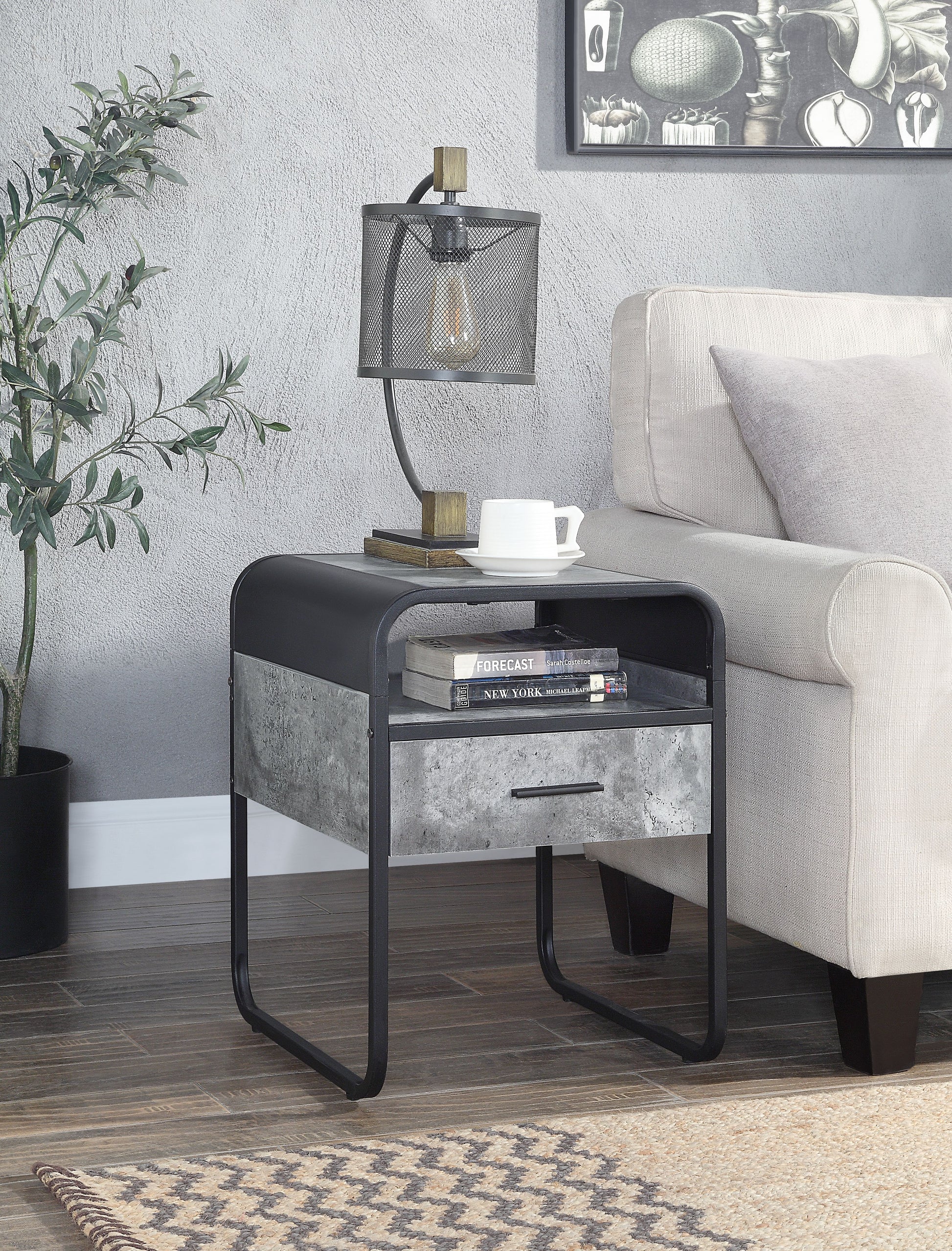 Modern industrial side table with black metal frame and concretelook drawer