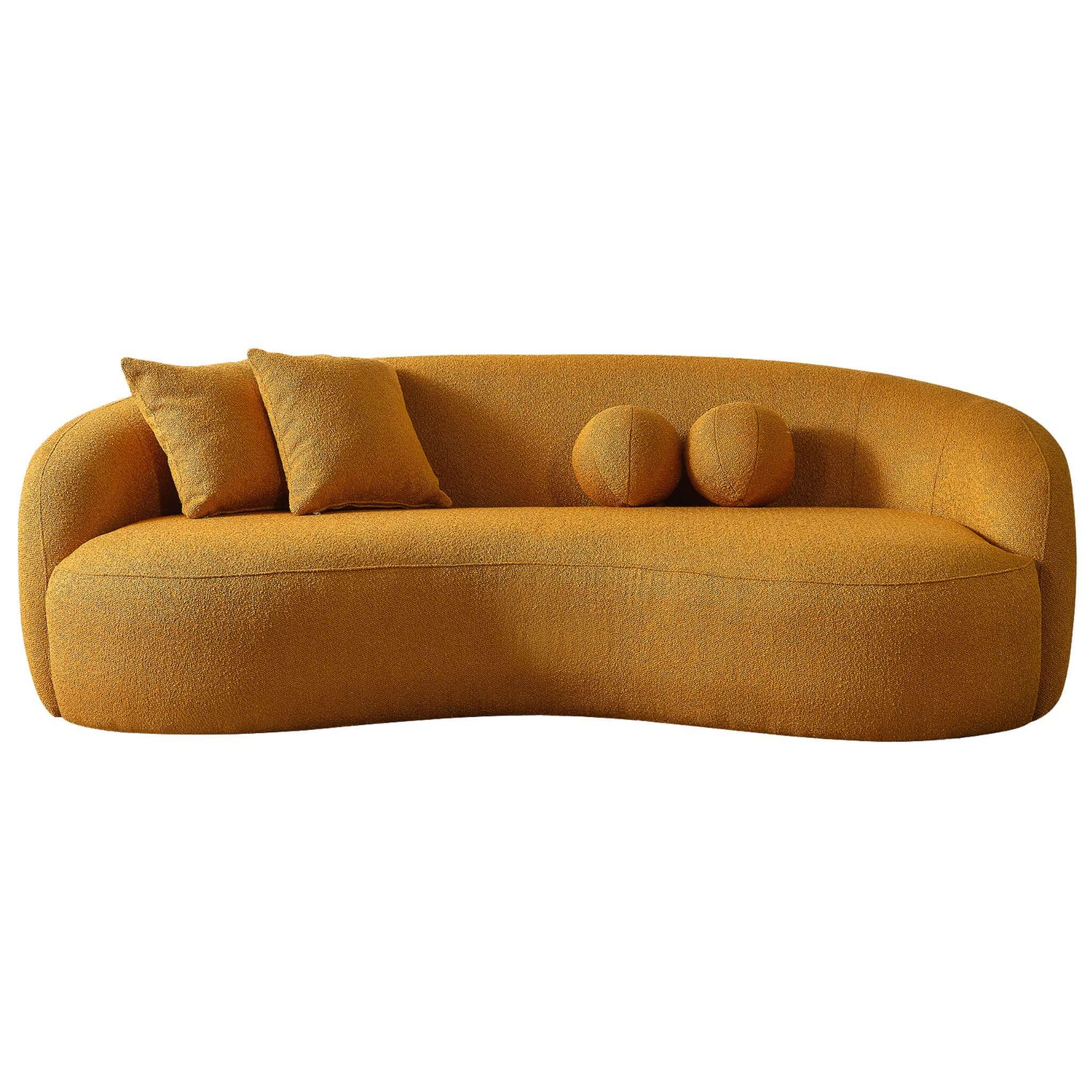 Curved ochre boucle sofa with plush back cushions and two round bolster pillows modern accent furniture