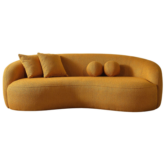 Curved ochre boucle sofa with plush back cushions and two round bolster pillows modern accent furniture