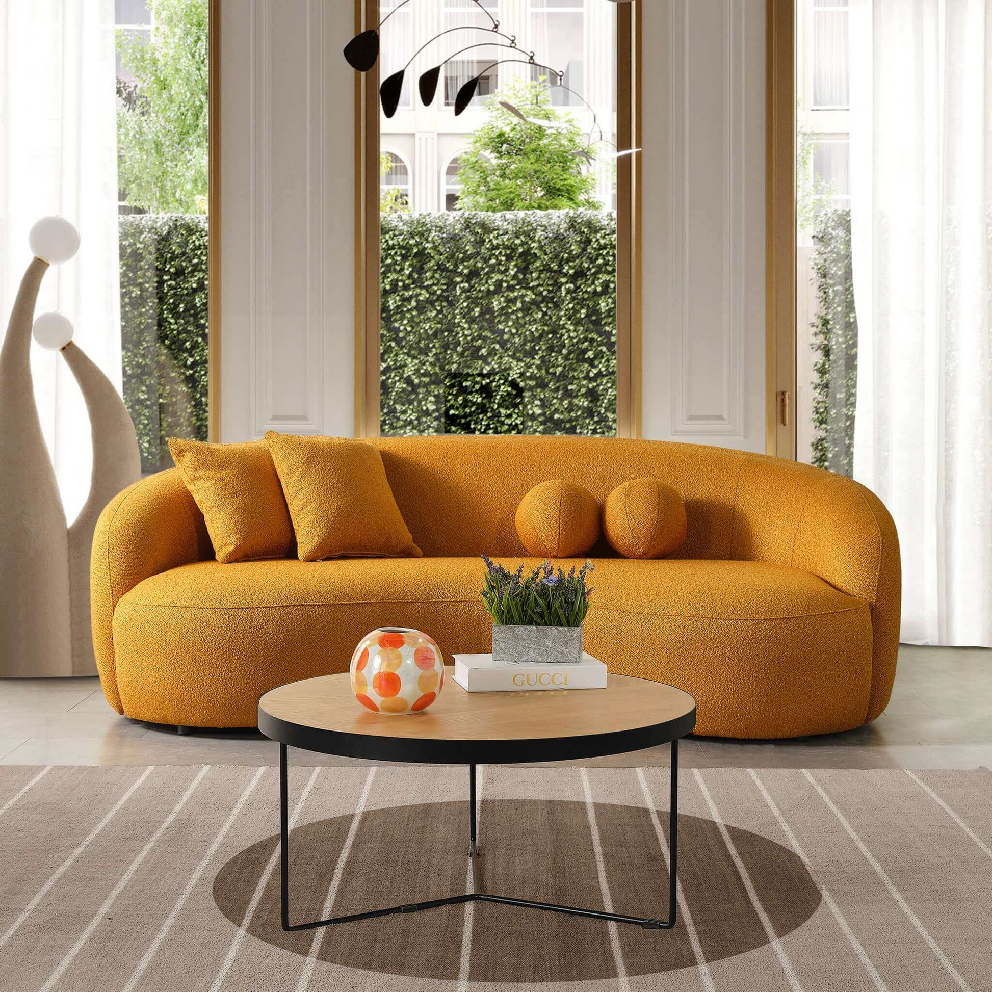 Modern orange boucl sofa with curved arms and plush throw pillows