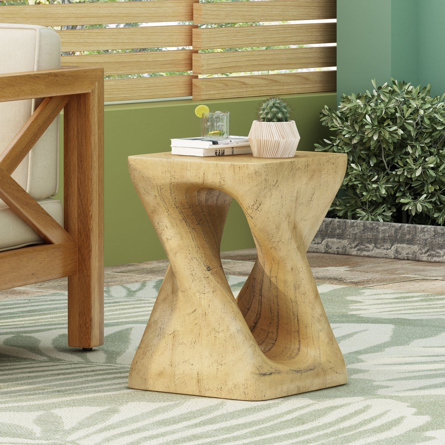 Sculptural light wood accent table with a twisting hourglass shape perfect for patio decor