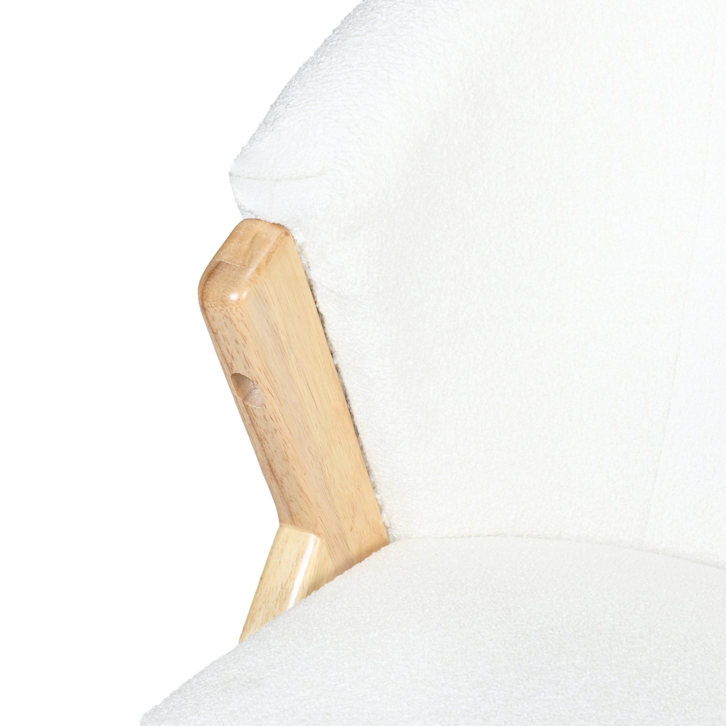 Closeup of a plush white boucle armchairs armrest and seat cushion