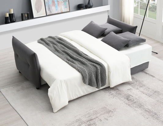 Dark gray fabric sofa bed with white bedding and a knit throw versatile for small spaces