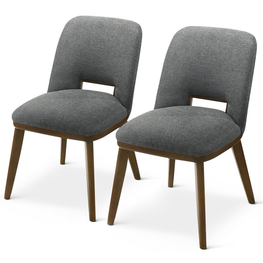 Two grey upholstered dining chairs with wooden legs and a cutout detail on the back