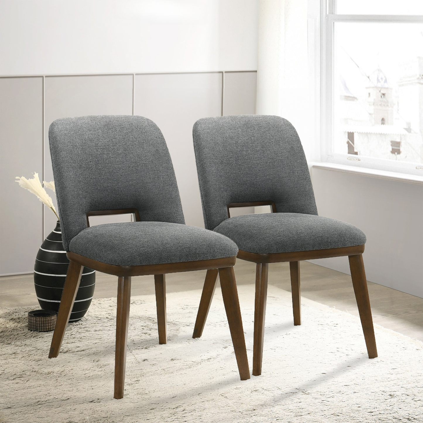Two upholstered gray dining chairs with dark wood legs