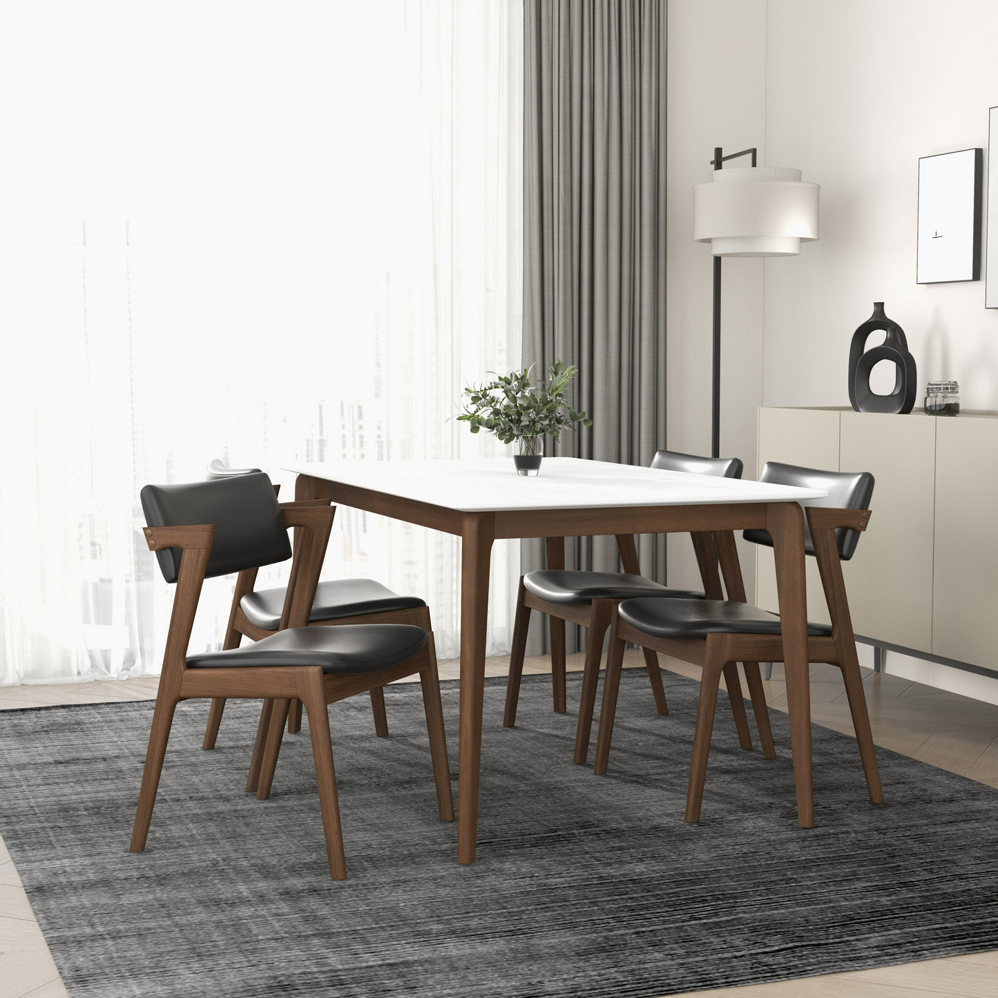 Modern white dining table with sleek black chairs and walnut wood legs