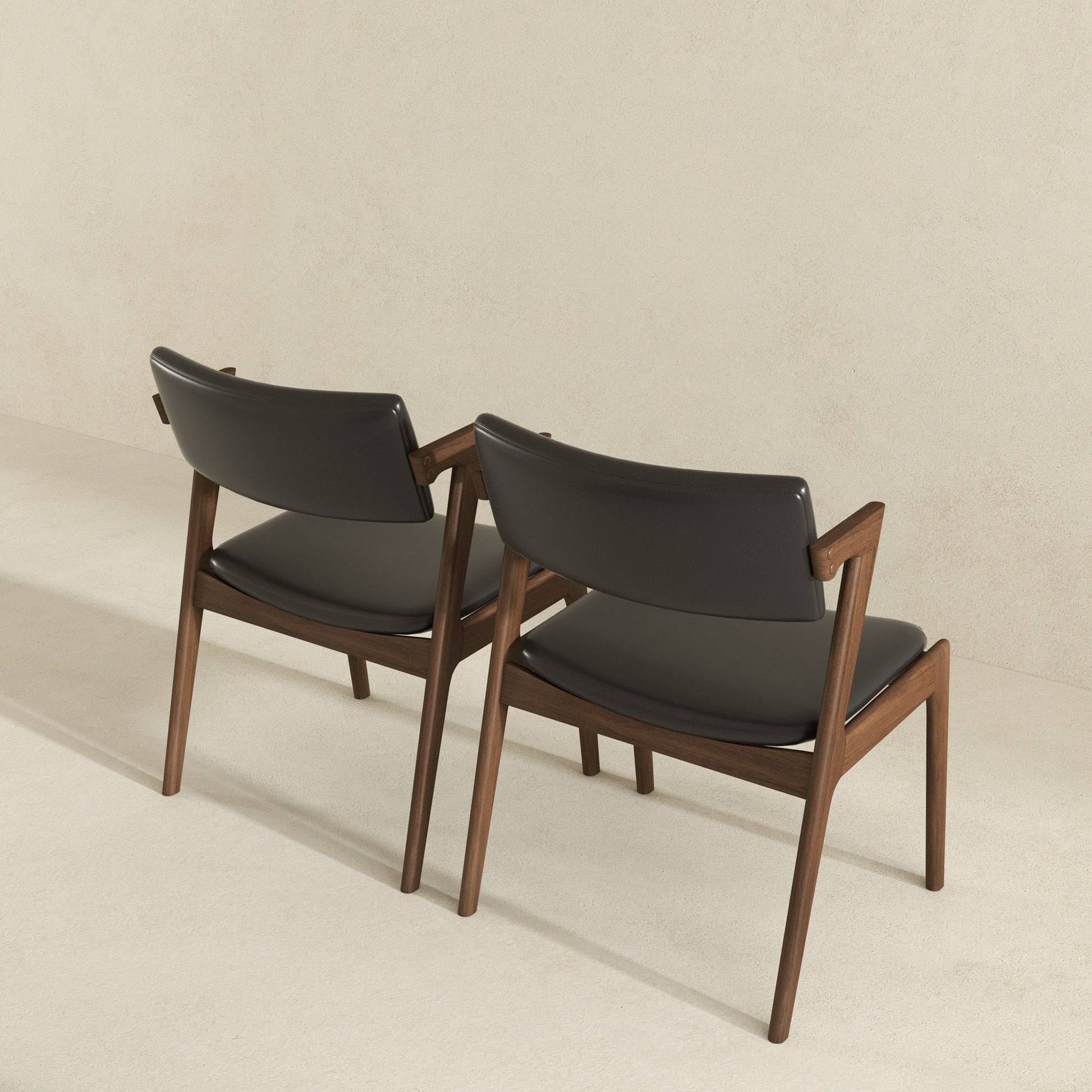 Black leather dining chair with walnut wood frame and arms
