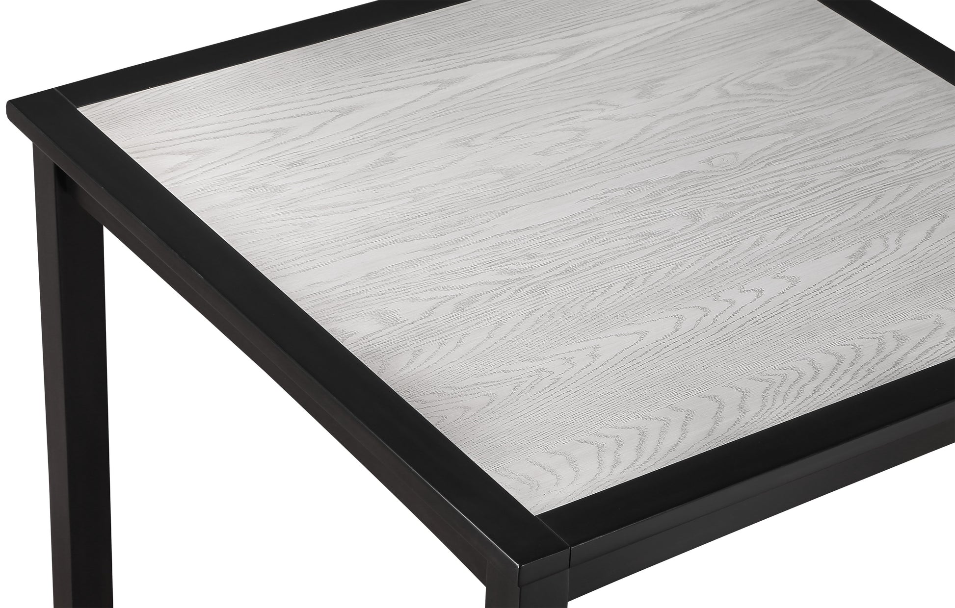 Closeup of a black metal framed table with a light grey wood grain surface