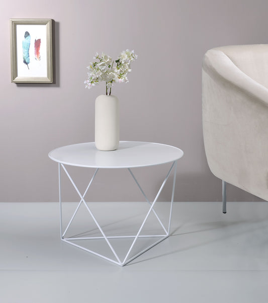 White geometric metal side table with round top holding a vase of white flowers