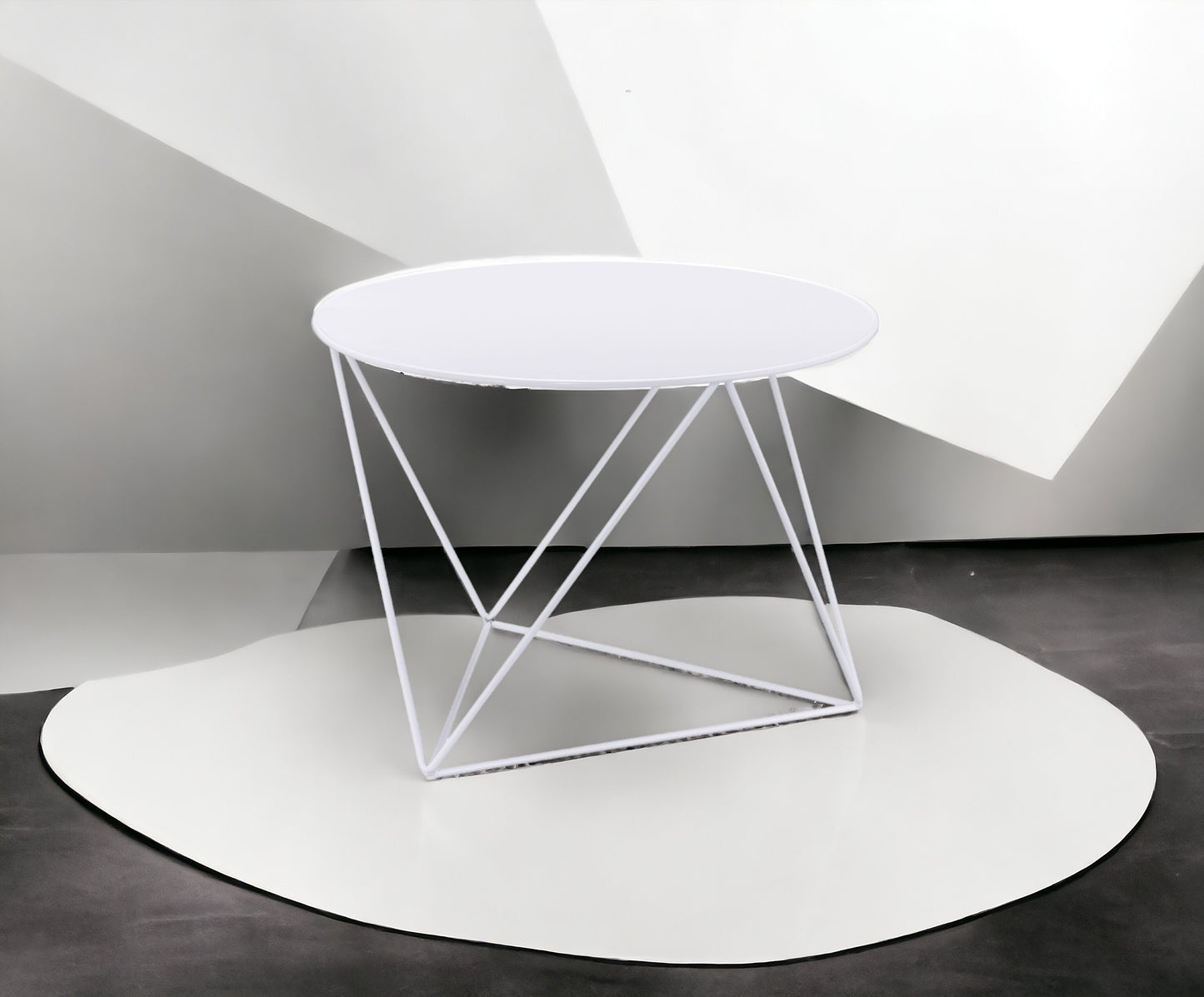 Modern white metal coffee table with geometric base and round top