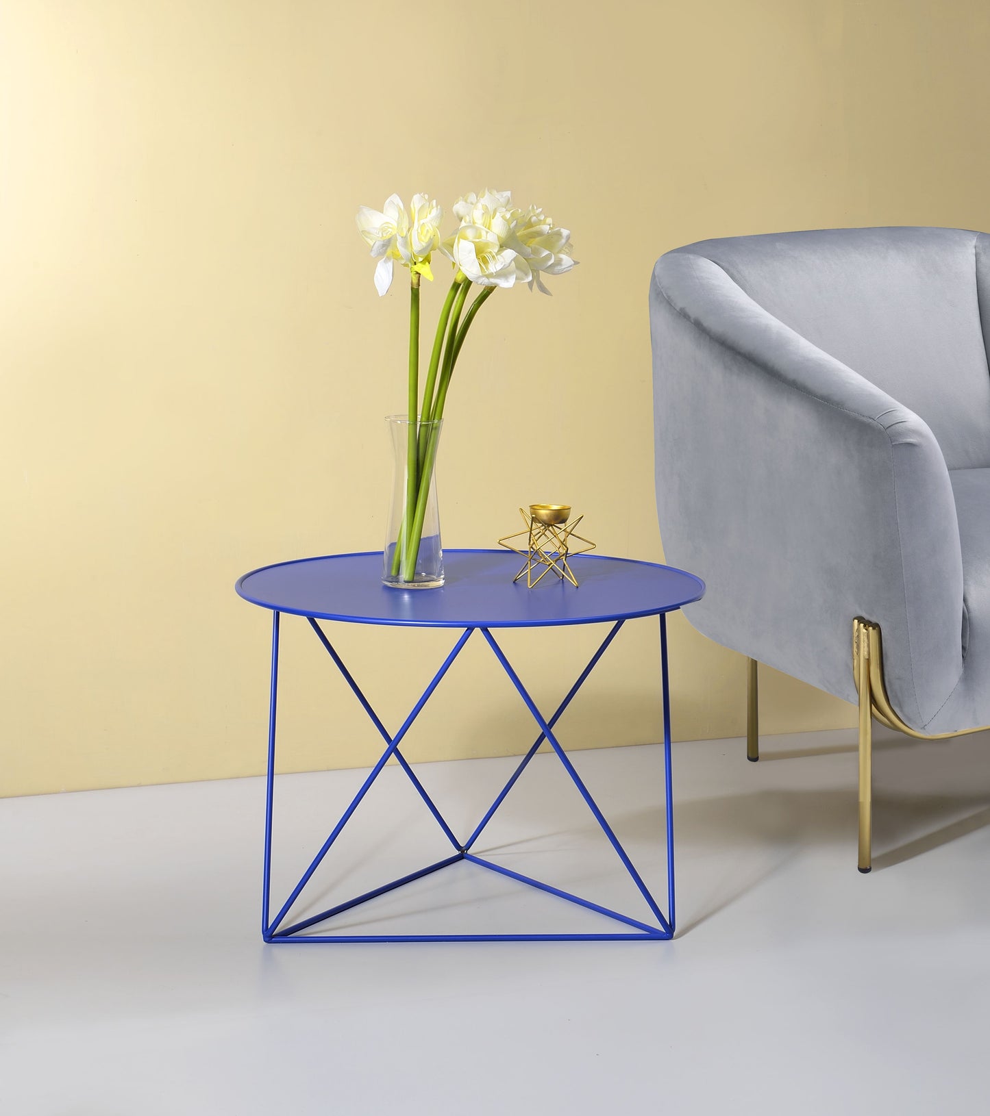 Vibrant blue metal accent table with a modern geometric base perfect for living rooms