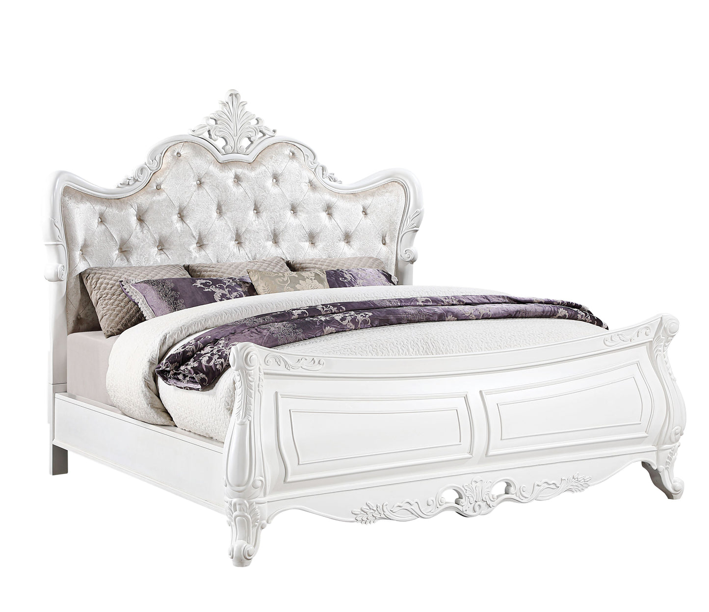 Ornate white upholstered king bed with button tufting and carved details