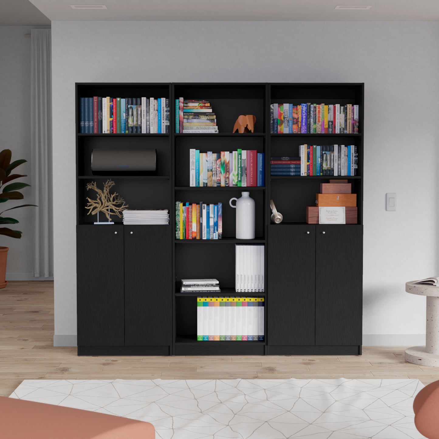 Modern black modular bookshelf with open shelves and closed cabinets storing books and decor