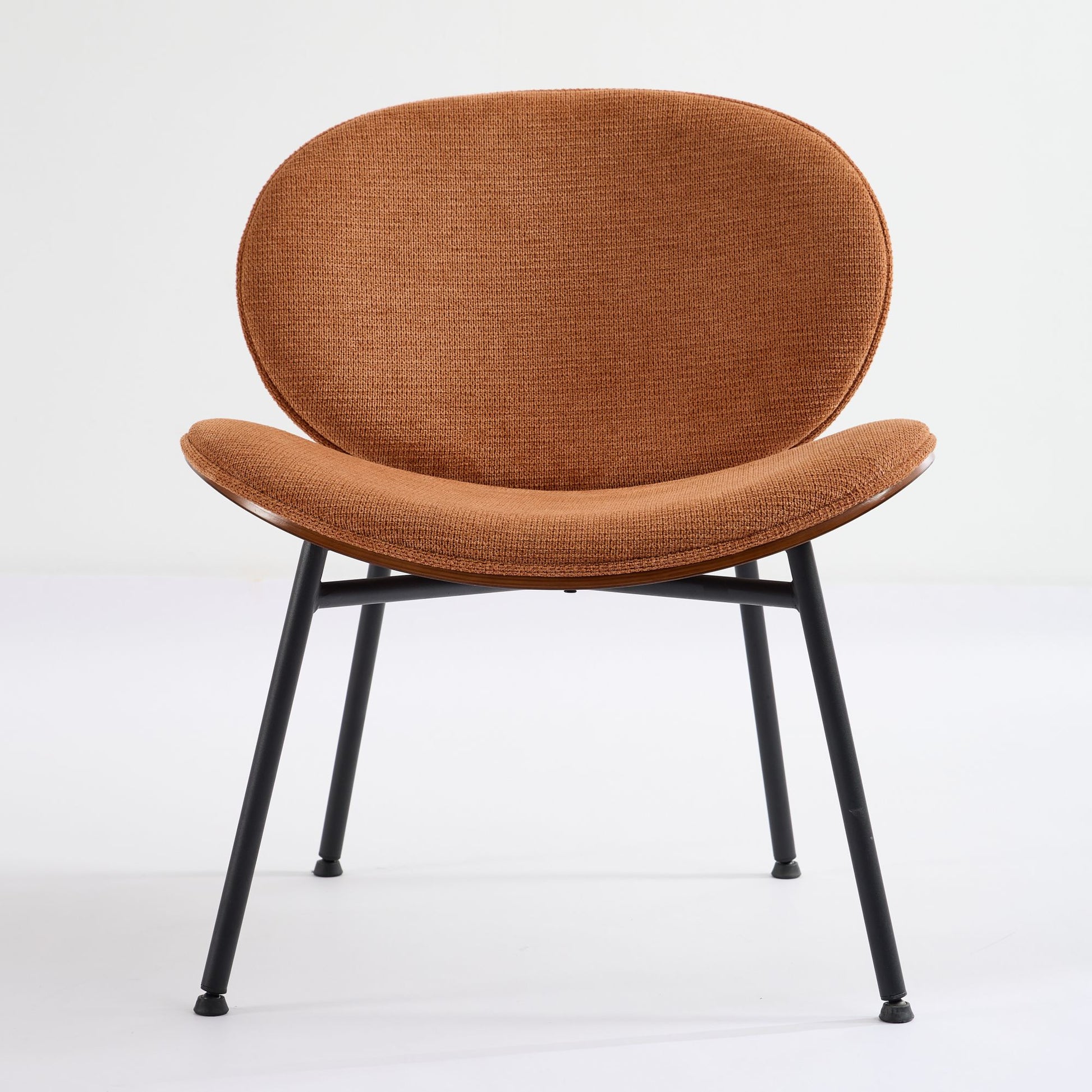Modern accent chair in burnt orange textured fabric with black metal legs