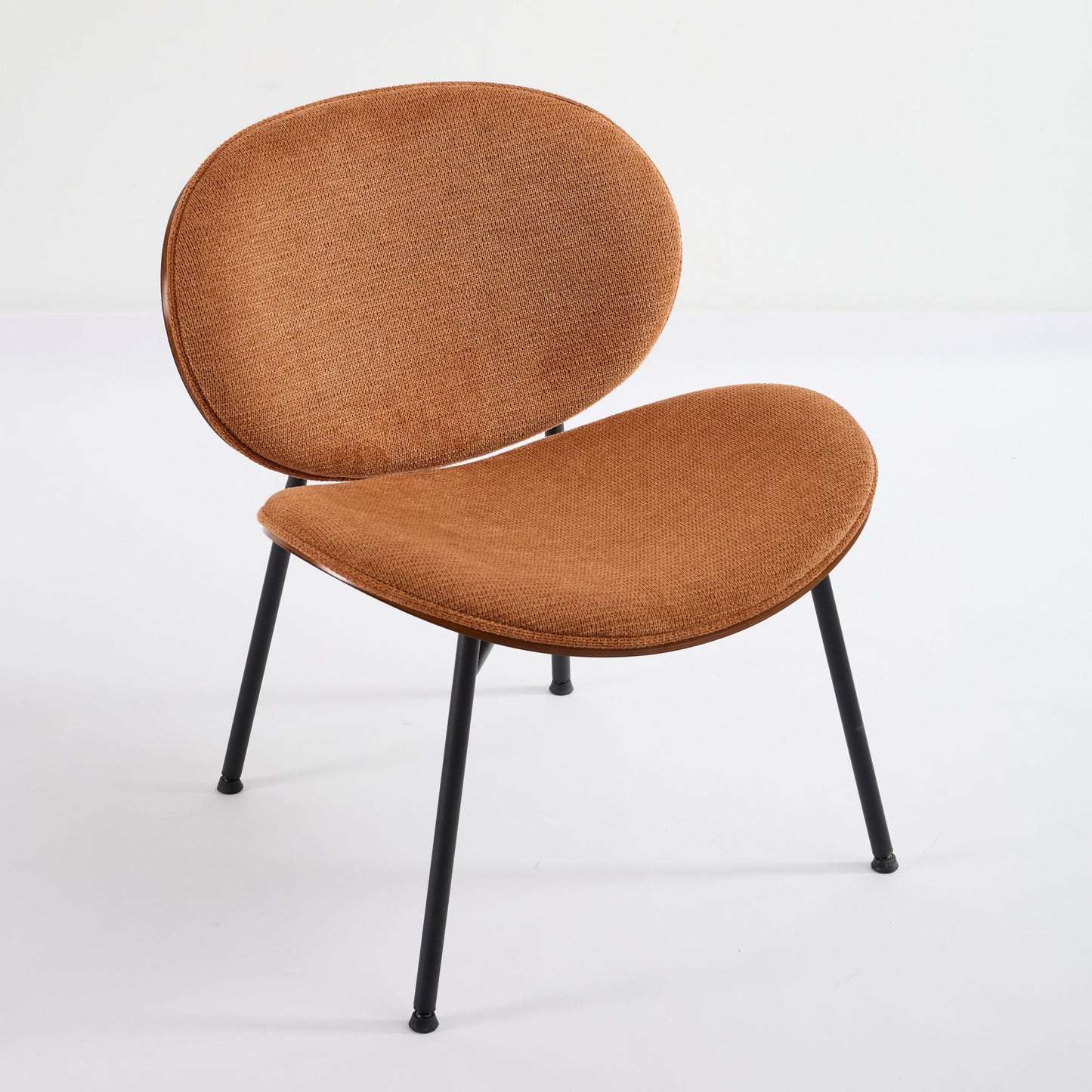 Brown upholstered accent chair with black metal legs and a curved design