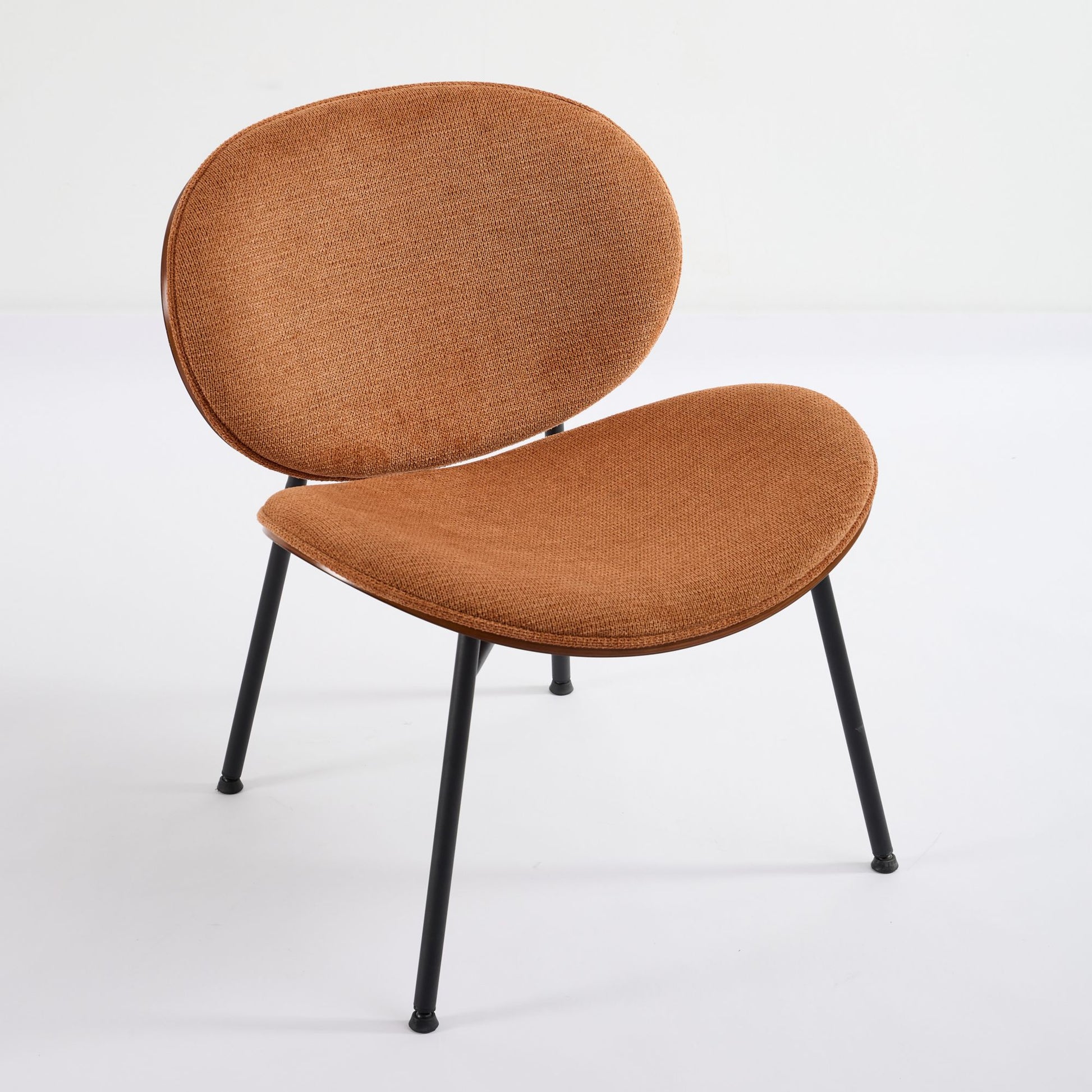 Brown upholstered accent chair with black metal legs and a curved design