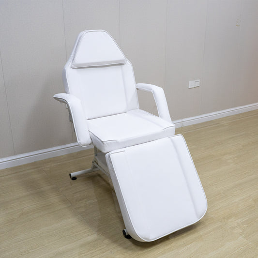 White hydraulic facial bed with adjustable headrest and leg rest for beauty salons