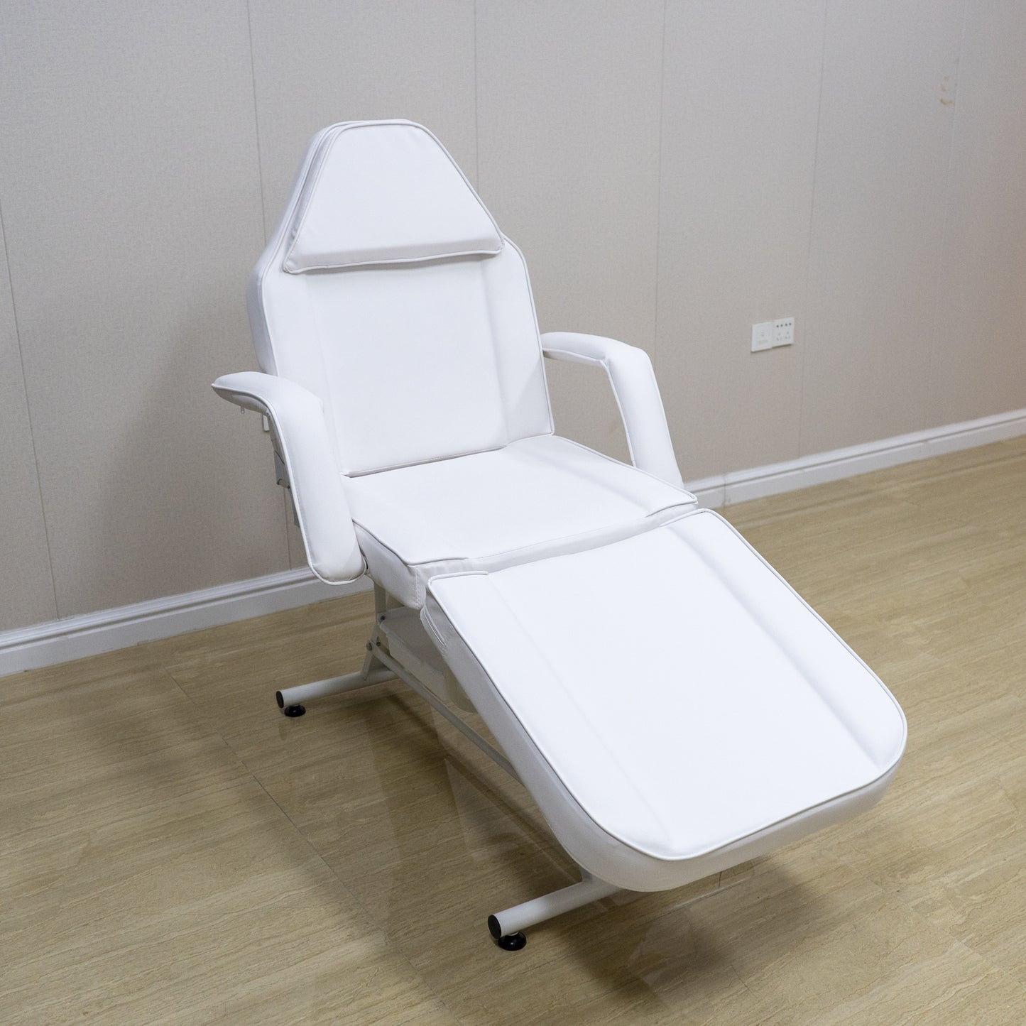 Adjustable white faux leather spa chair with headrest and leg rest for beauty treatments
