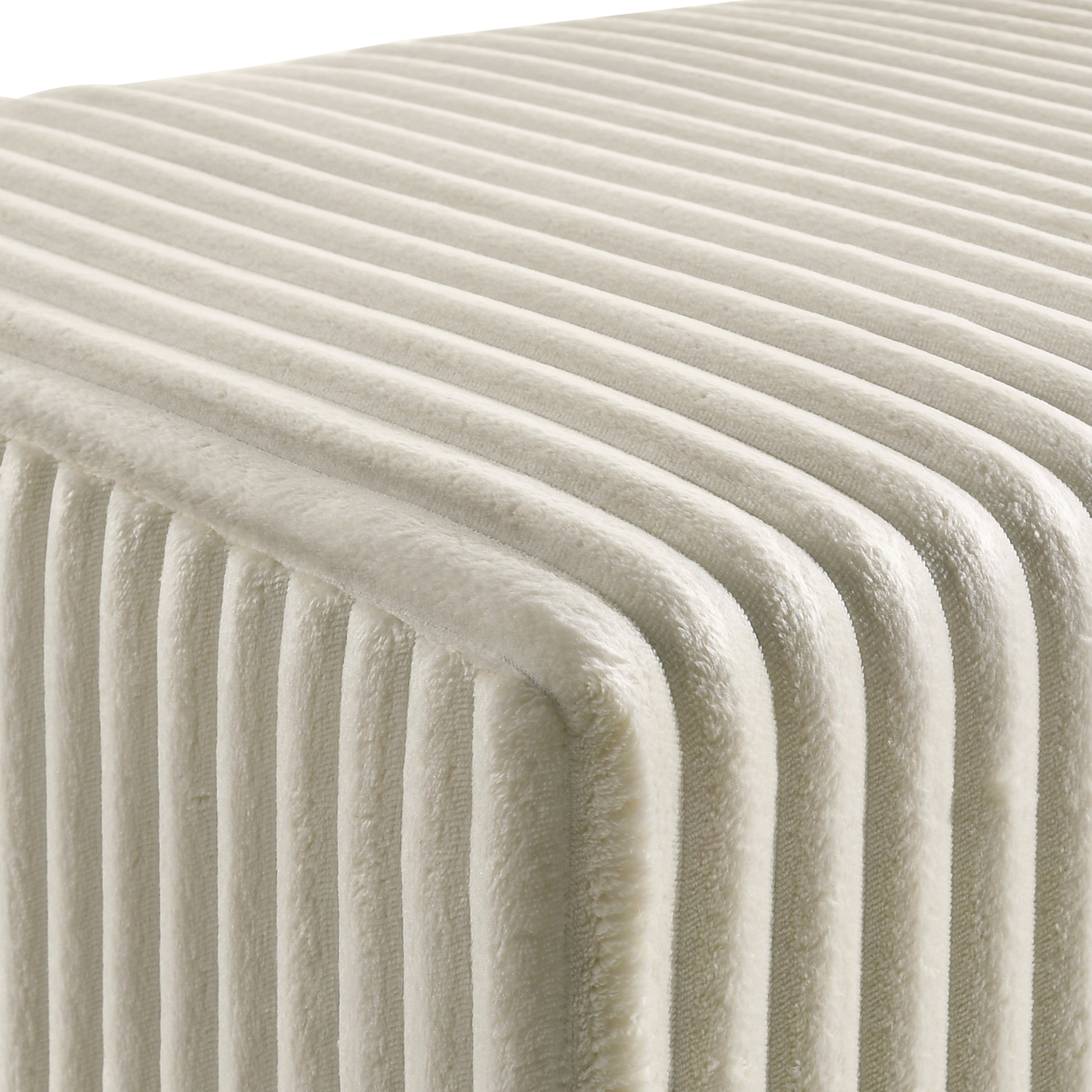 Cream velvet textured ottoman with raised ribbed pattern