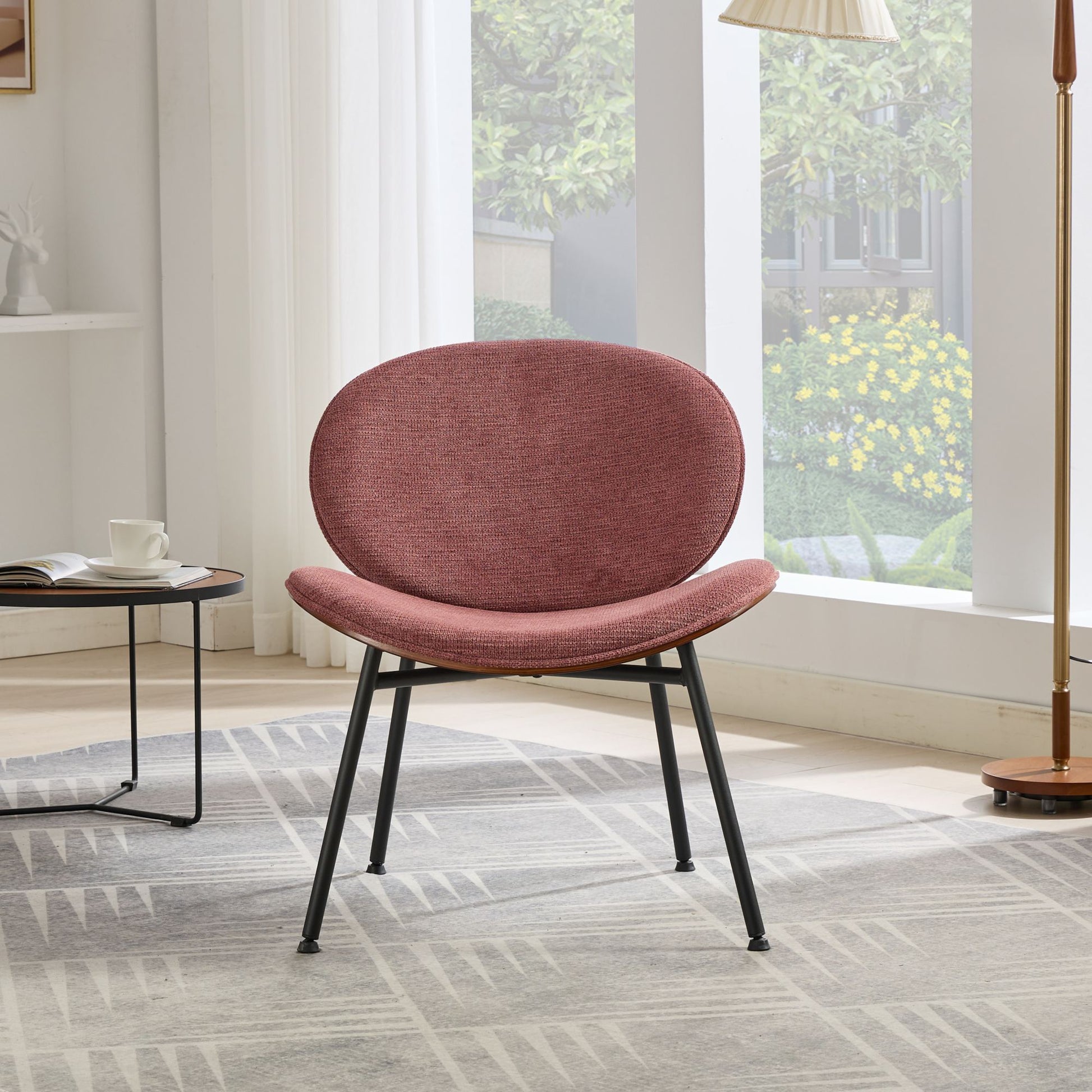 Midcentury modern accent chair in dusty rose fabric with black metal legs perfect for a living room