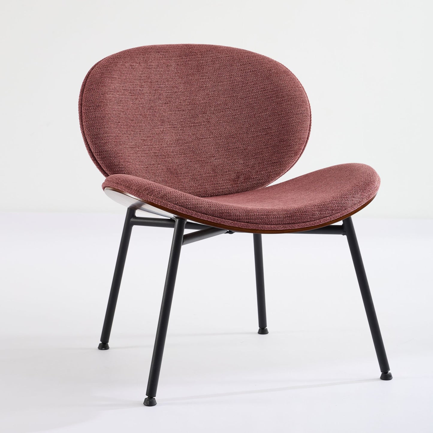Modern rosehued fabric accent chair with sleek black metal legs and a curved ergonomic design