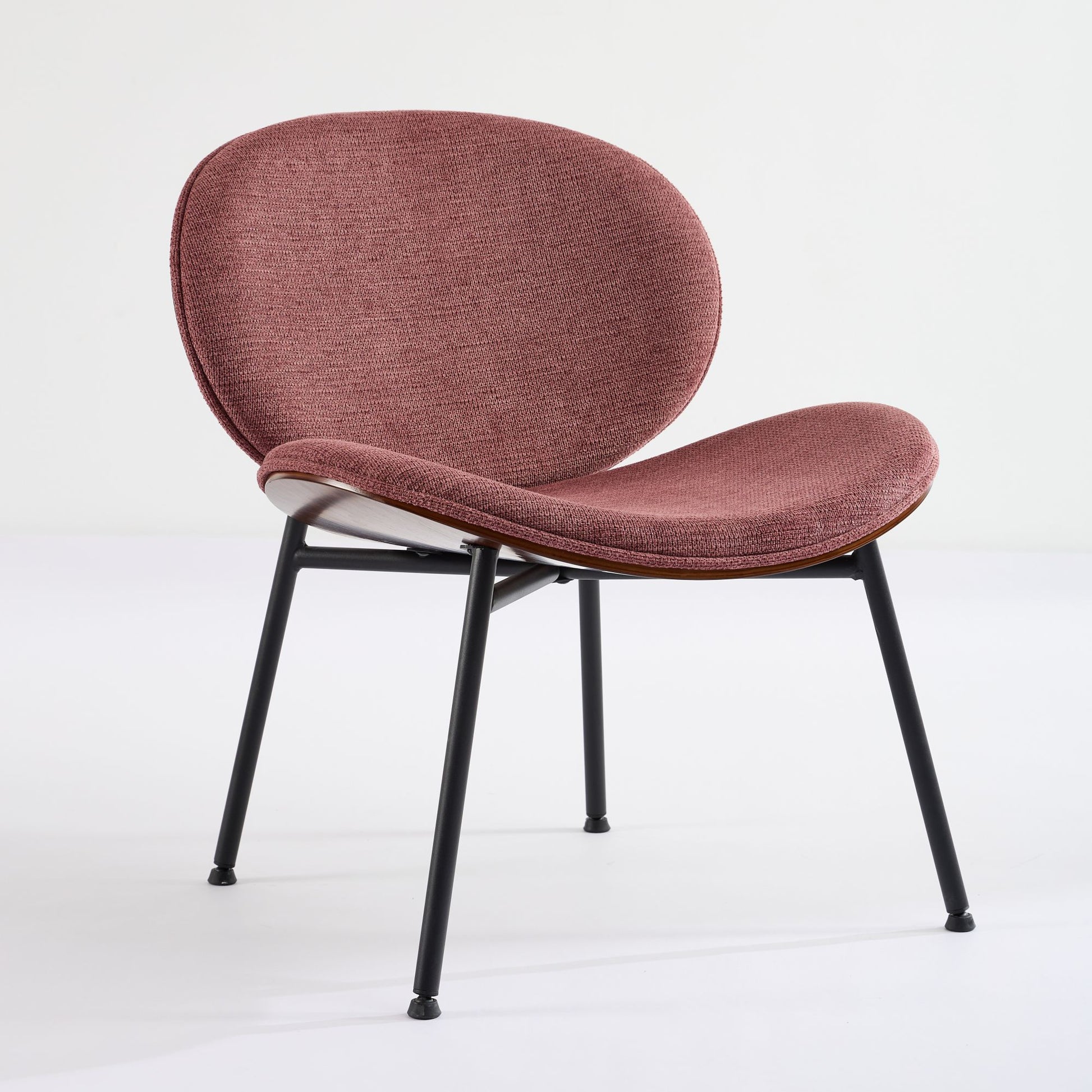 Dusty rose upholstered accent chair with slim black metal legs