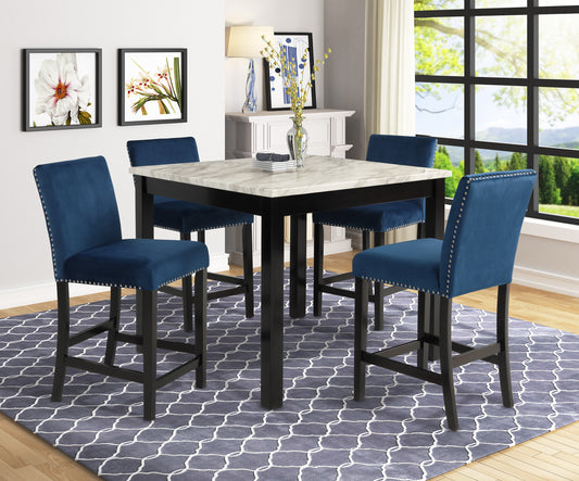 Four navy blue velvet bar stools with silver nailhead trim surround a faux marble top bar table