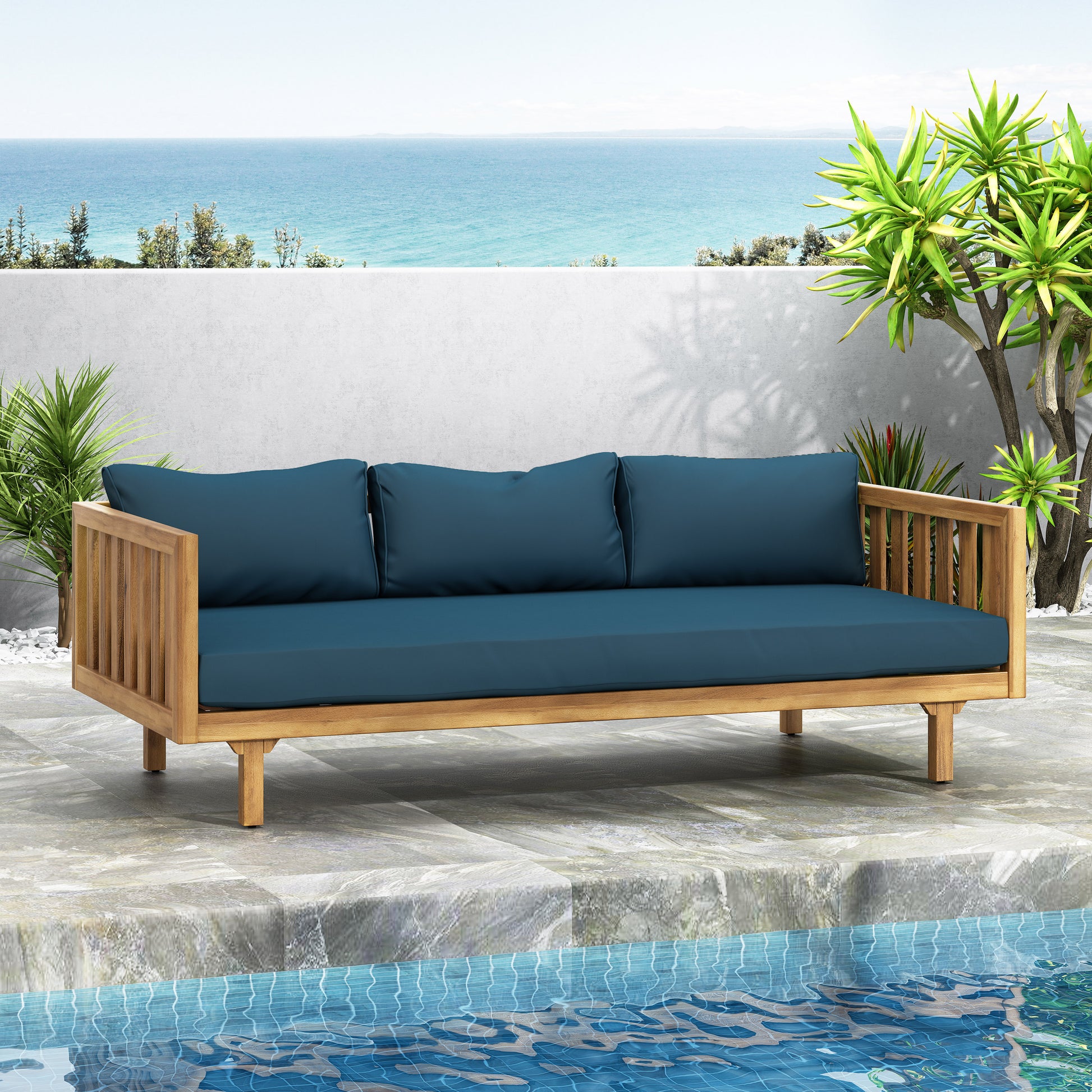 Teak wood outdoor sofa with deep blue cushions perfect for poolside lounging