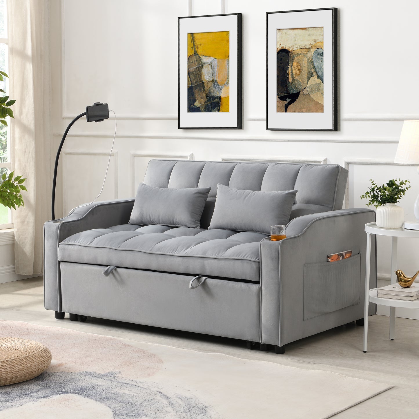 Grey velvet convertible sofa bed with tufted cushions and storage pockets