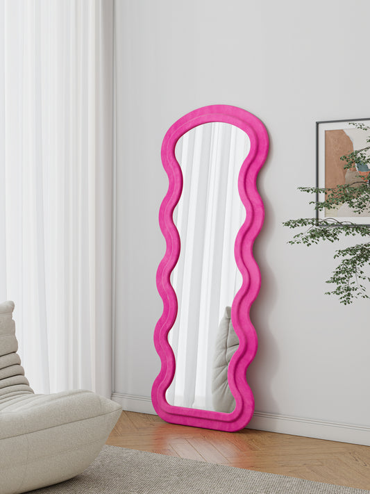 Hot pink wavy floor mirror with plush velvet frame for modern home decor