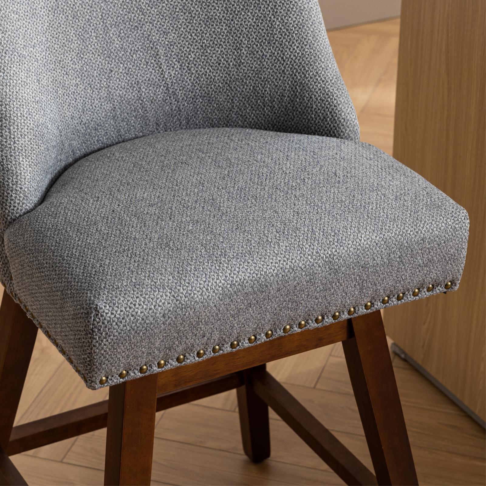 Gray textured fabric stool with brass nailhead trim and dark wood legs