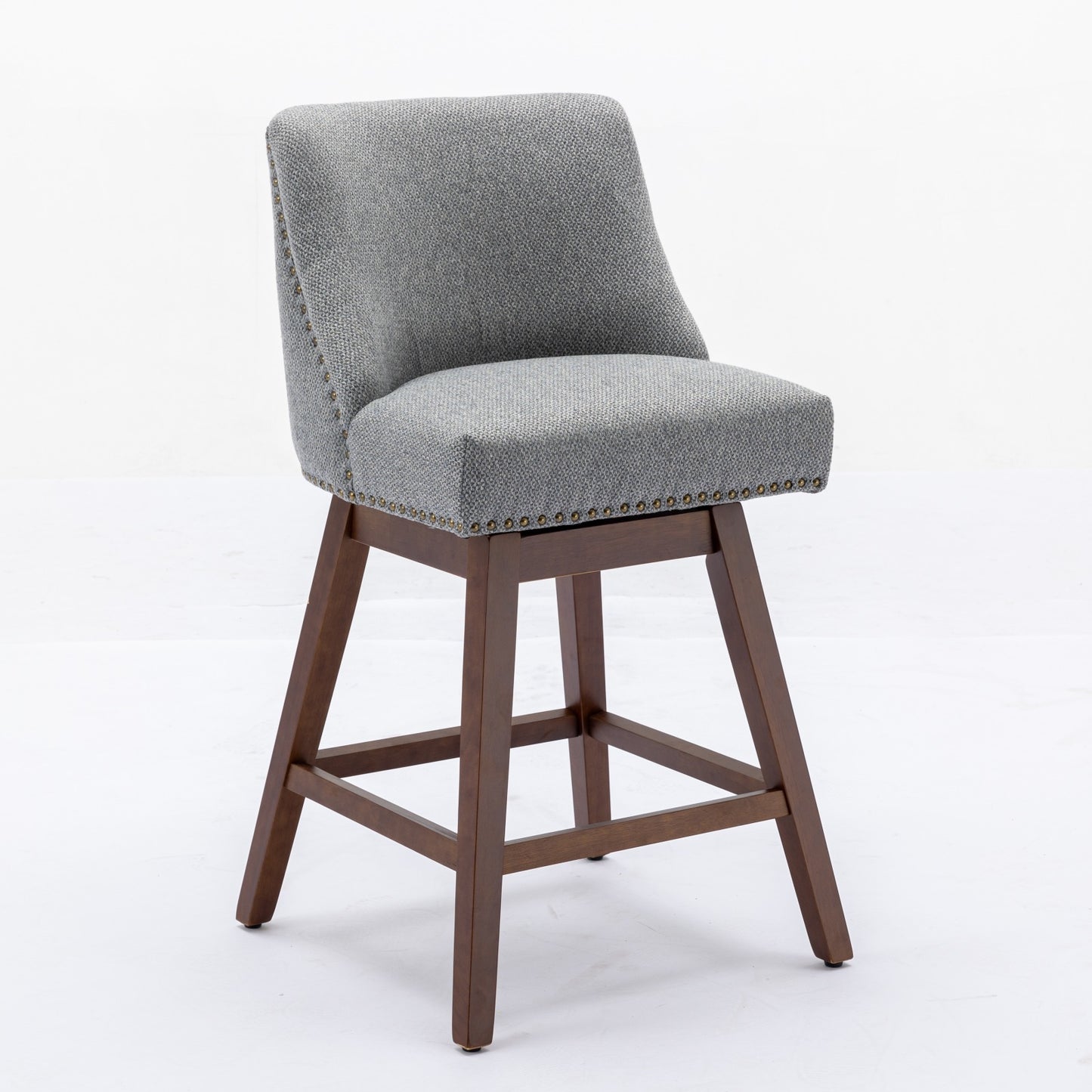 Gray upholstered swivel bar stool with wood legs and brass nailhead trim