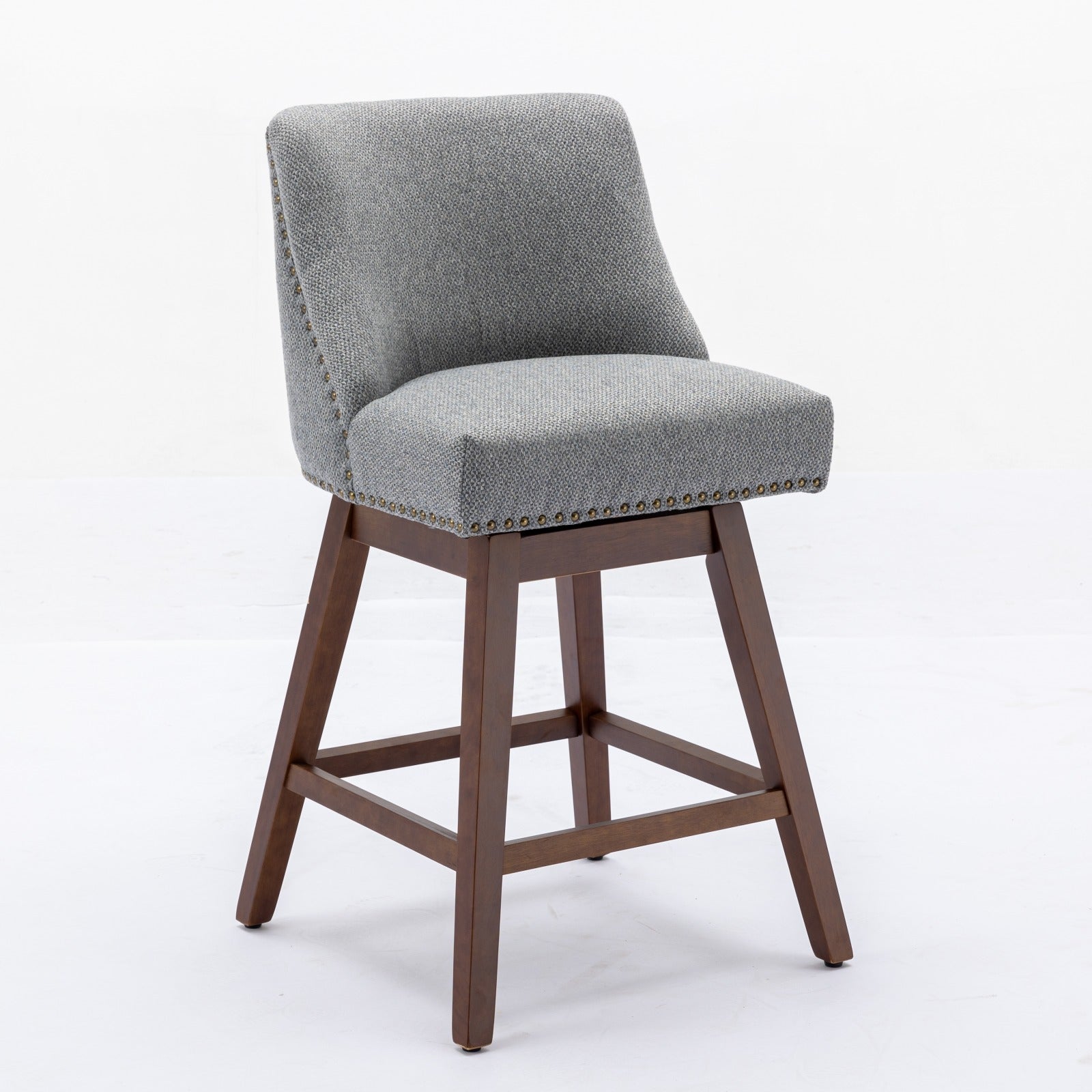 Gray upholstered swivel bar stool with wood legs and brass nailhead trim