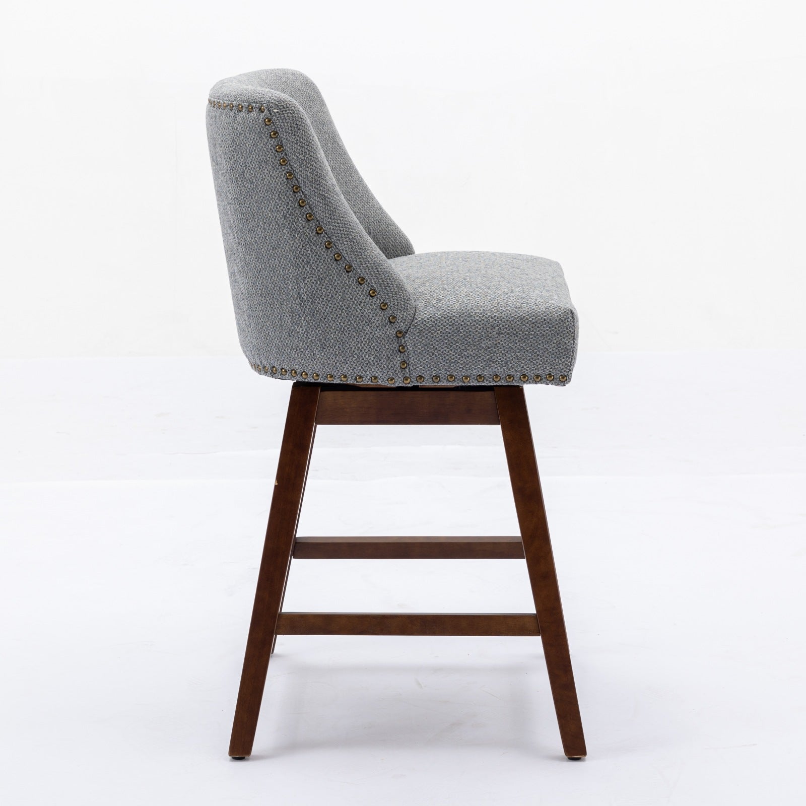 Gray upholstered swivel bar stool with bronze nailhead trim and wooden legs