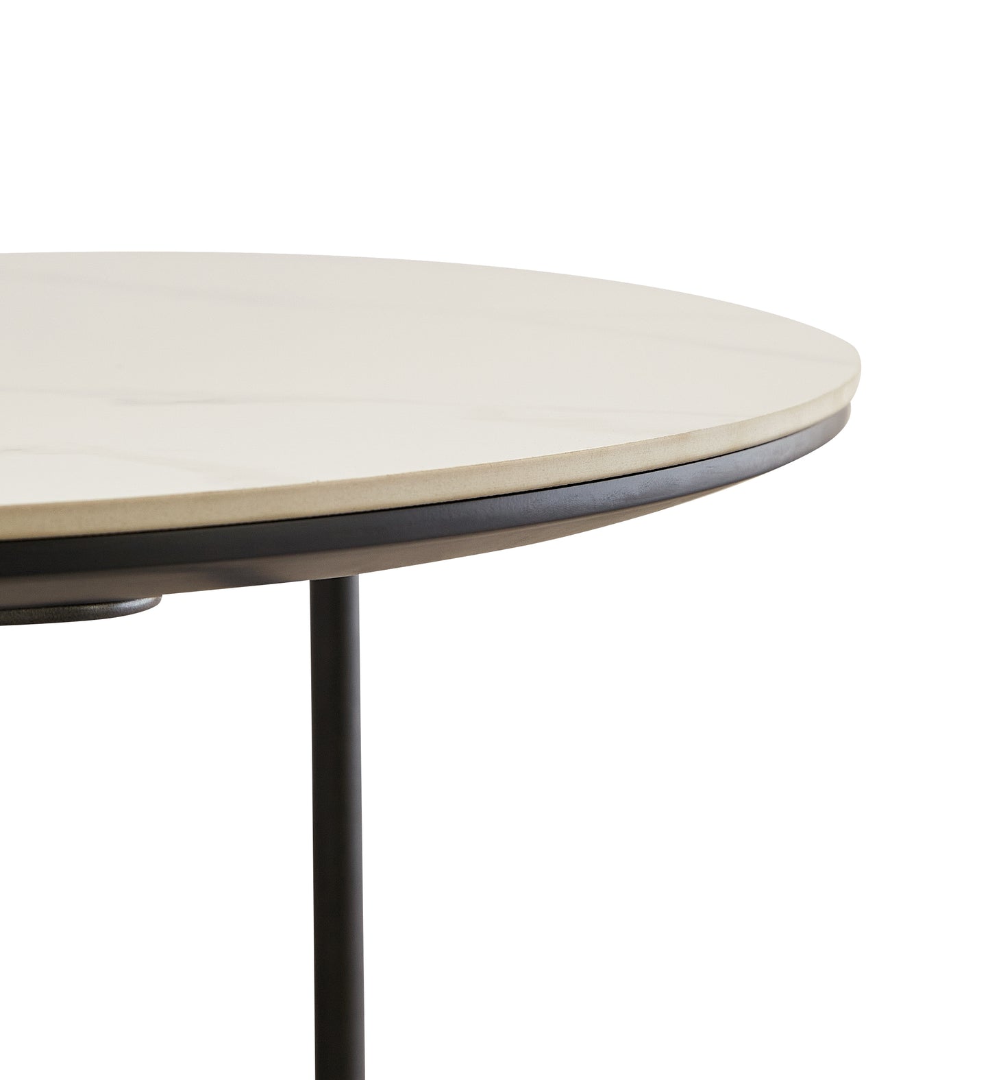 Closeup of a round light beige marble top table with a thin black edge and a single black leg