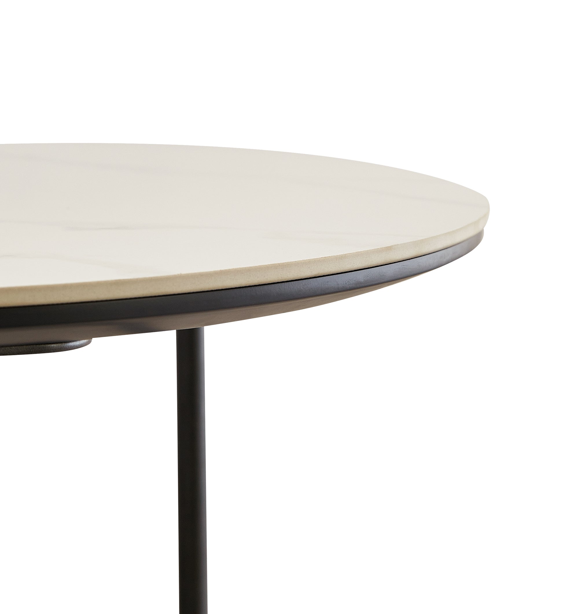 Closeup of a round light beige marble top table with a thin black edge and a single black leg