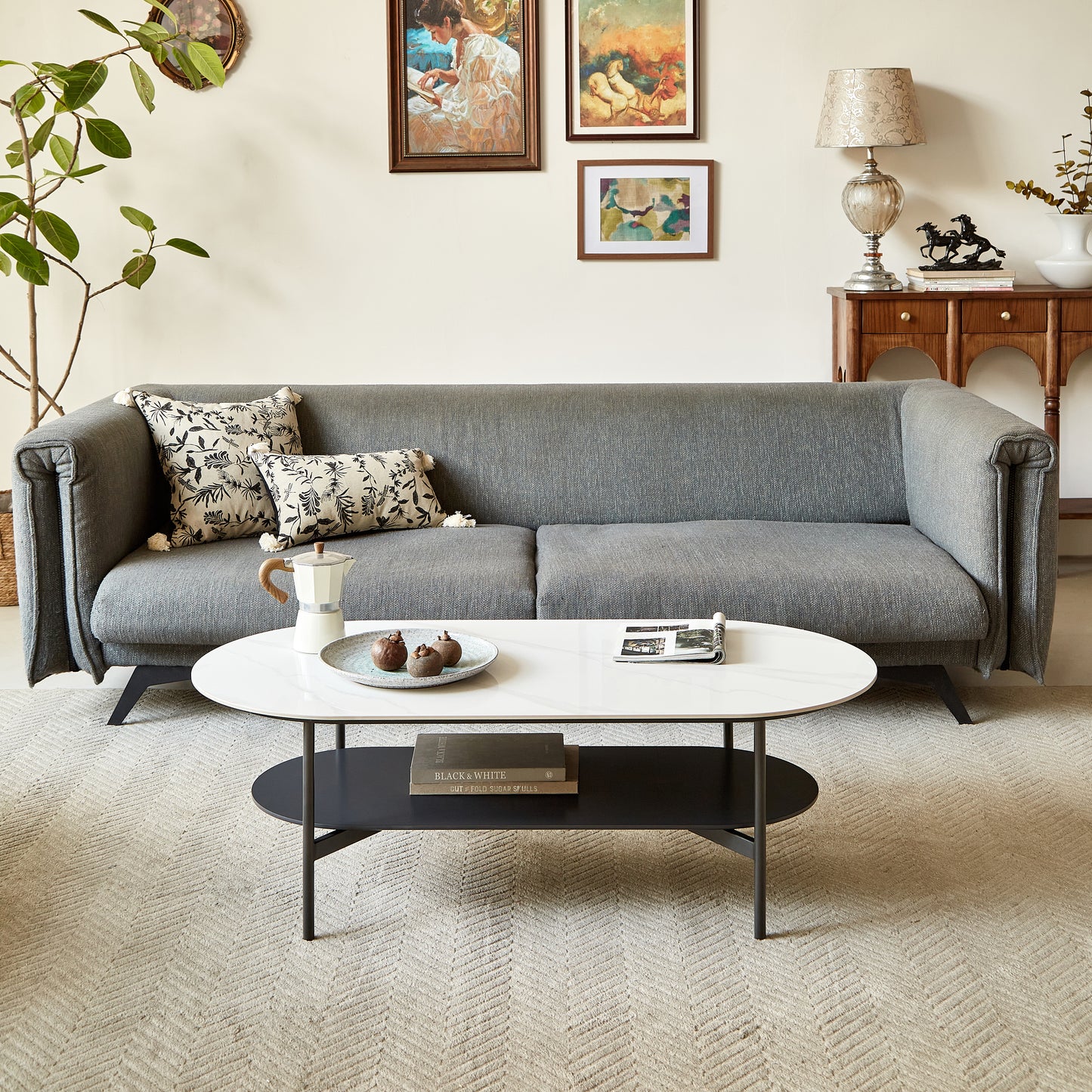 Midcentury modern grey sofa with decorative pillows and a marbletop coffee table