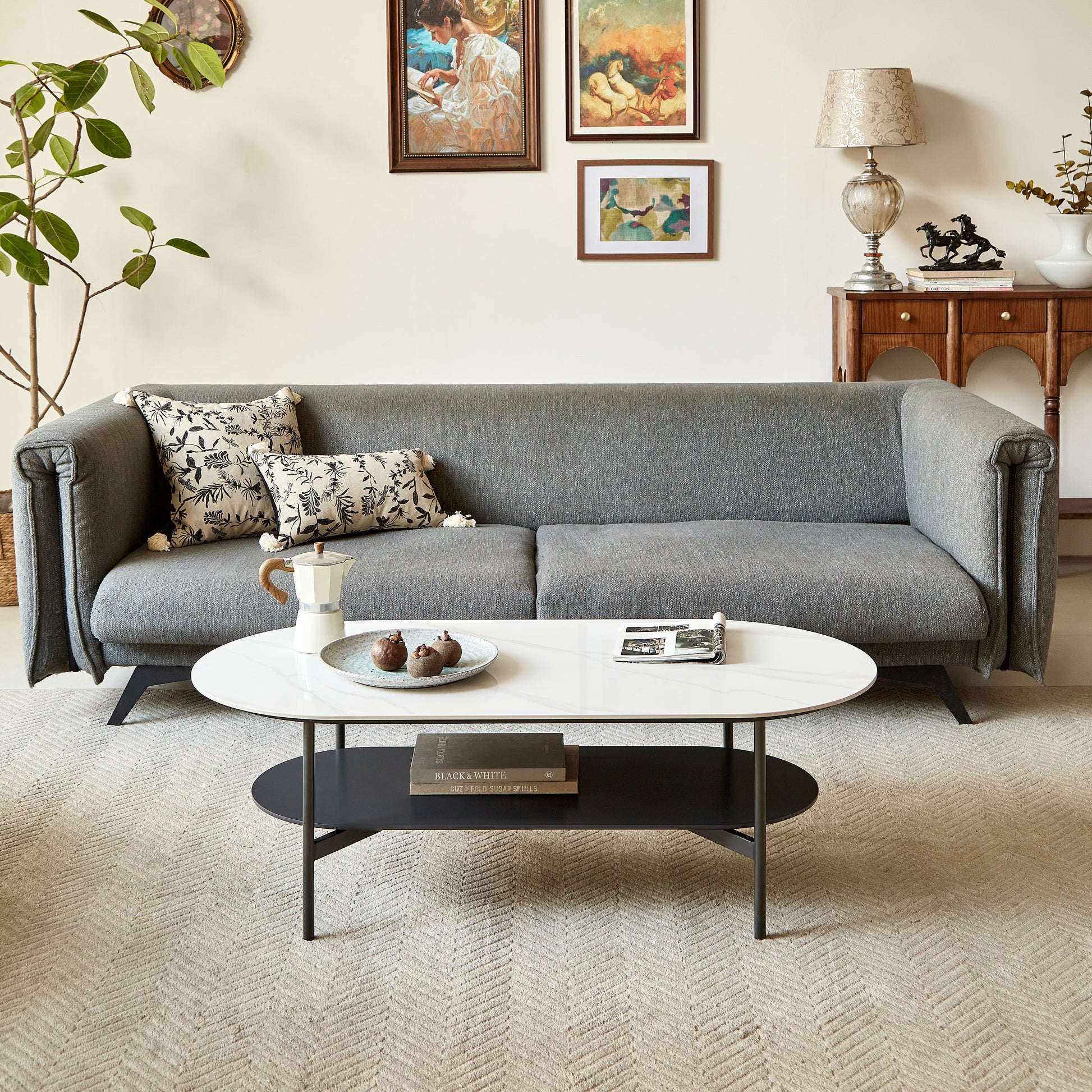 Midcentury modern grey sofa with decorative pillows and a marbletop coffee table