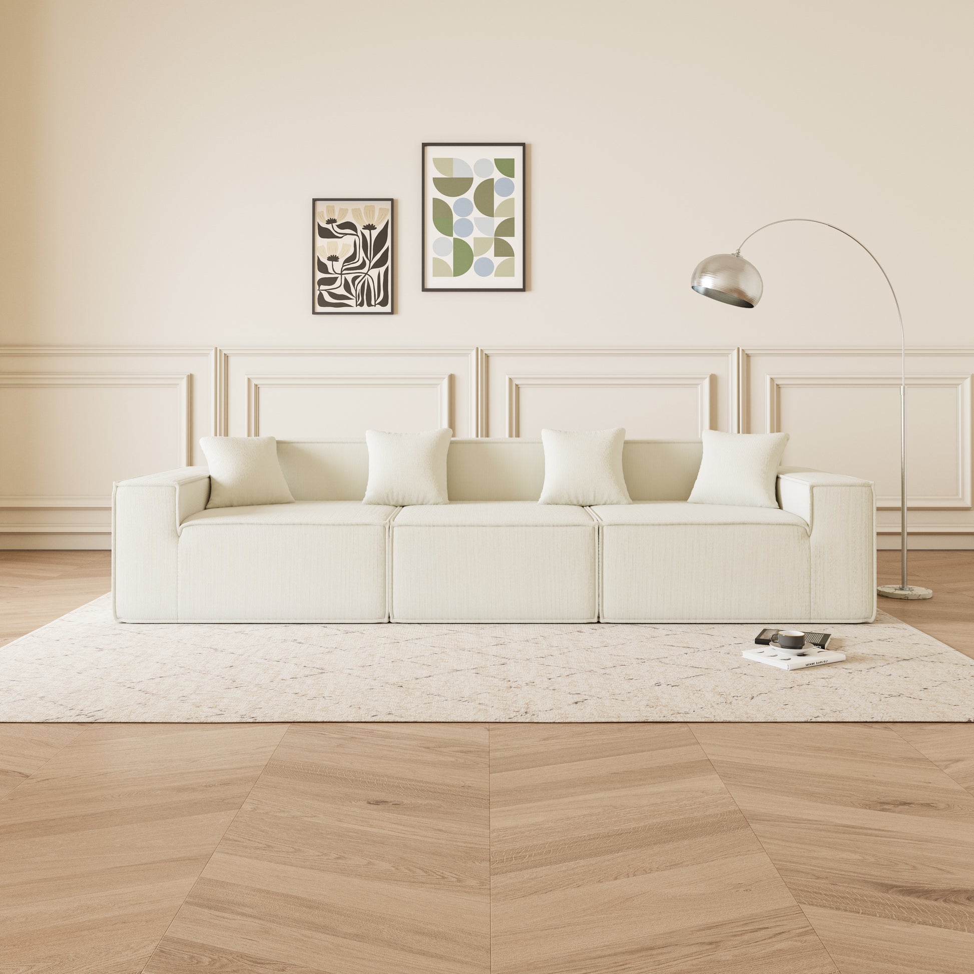 Modular cream corduroy sofa with plush pillows and minimalist art