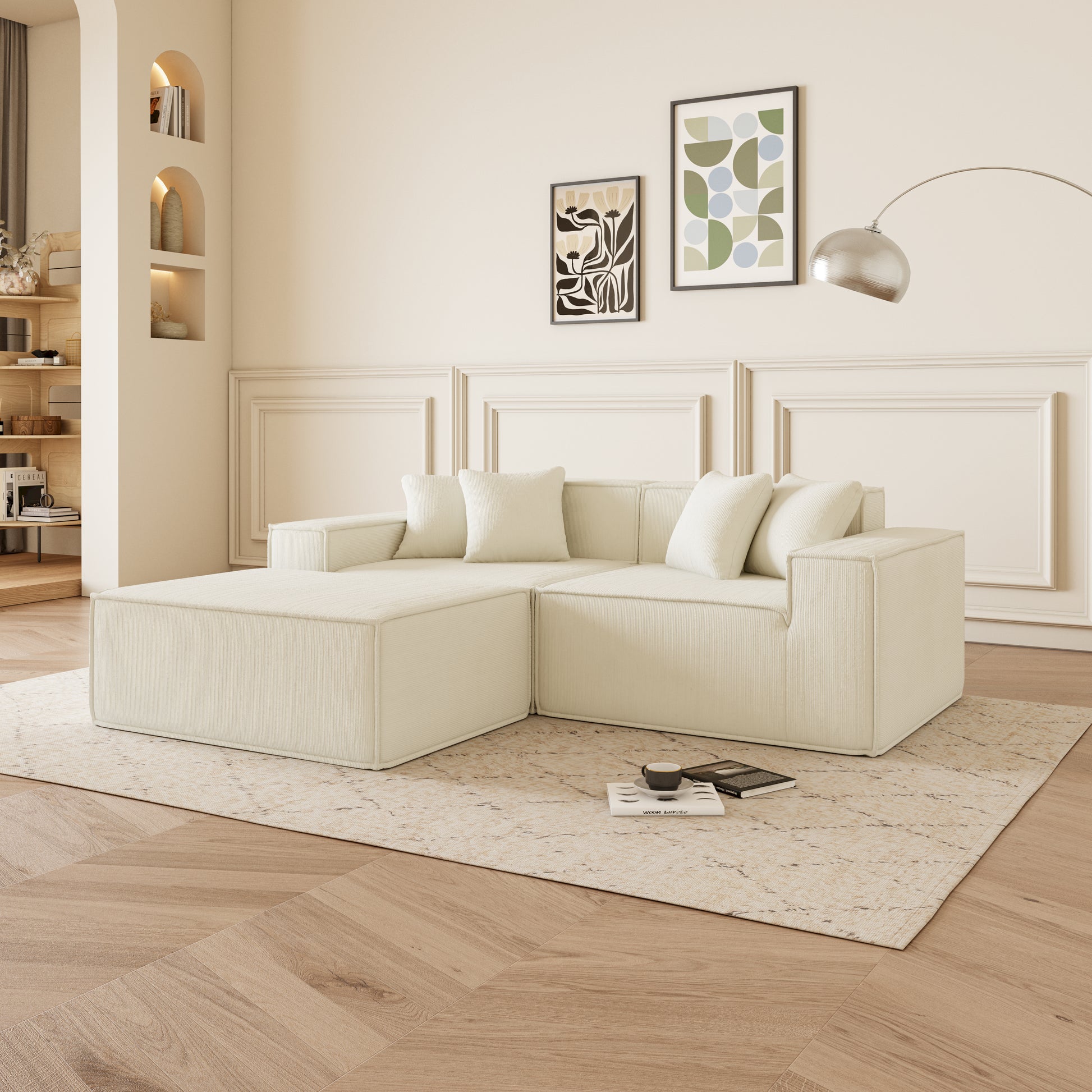 Cream modular sectional sofa with ottoman and plush cushions on a patterned rug