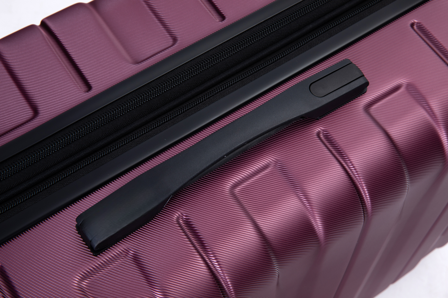 Durable plum hardside luggage with textured shell and sturdy black handle