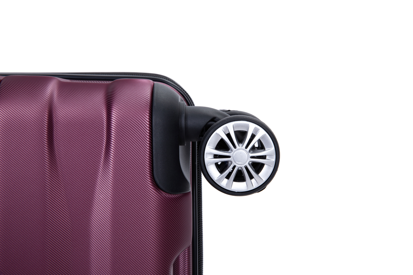 Closeup of a maroon suitcases textured surface and spinner wheel