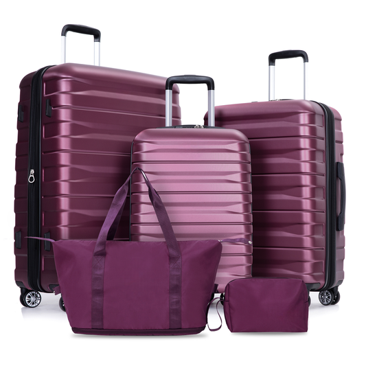 Deep plum hardside luggage set with matching duffel bag and cosmetic case