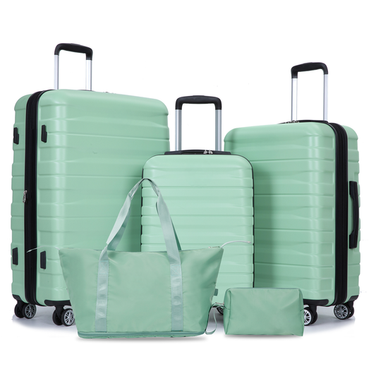 Fourpiece mint green luggage set with wheeled suitcases and matching travel bags