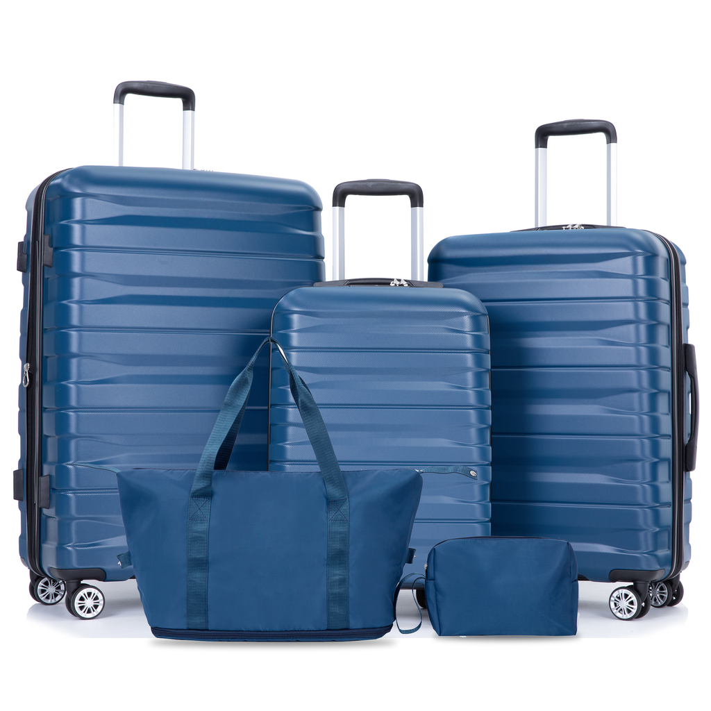 Set of four blue hardside luggage pieces including three suitcases and a duffel bag